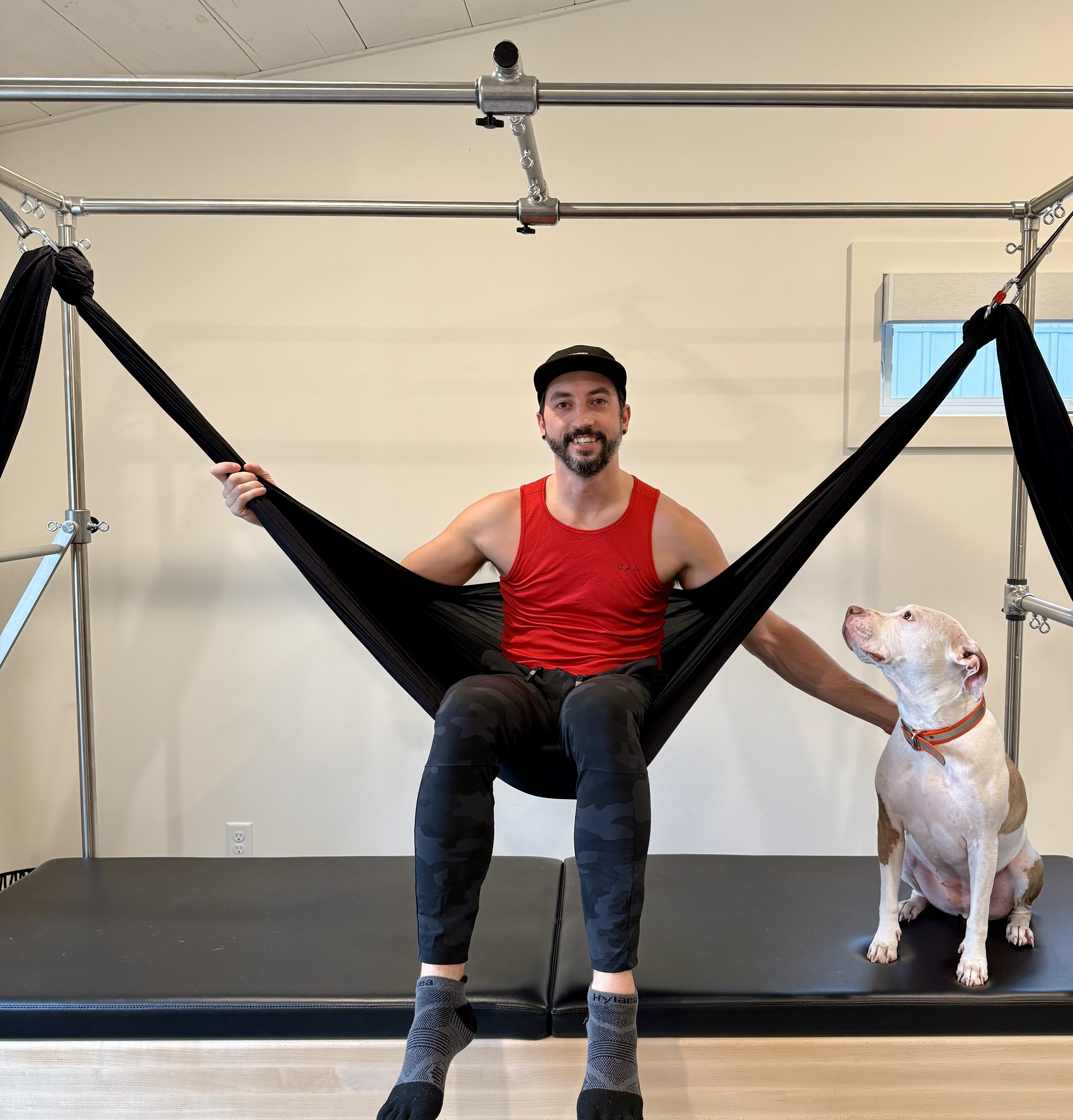 Bryan Tucker performing a middle split on a Pilates Cadillac